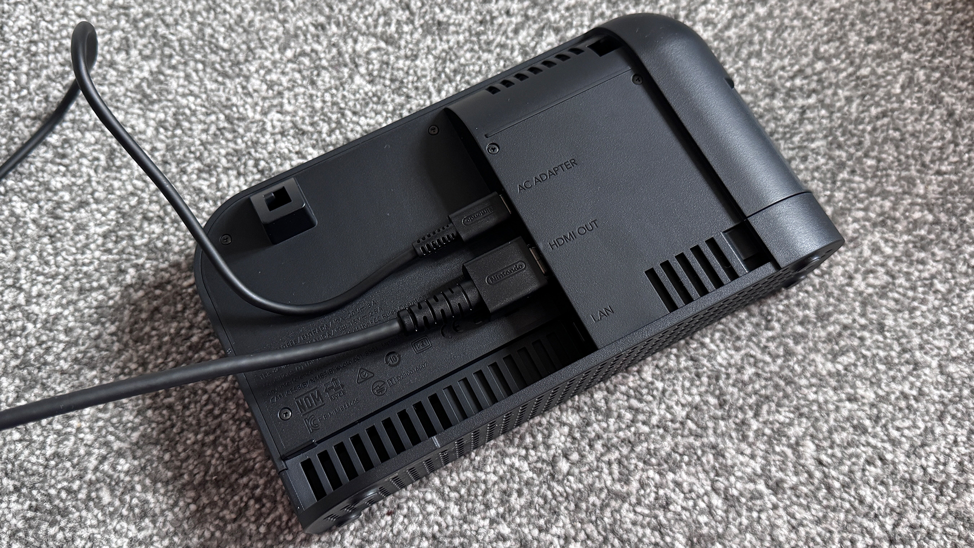 The Nintendo Switch 2 dock with power and HDMI cables attached and rear panel removed