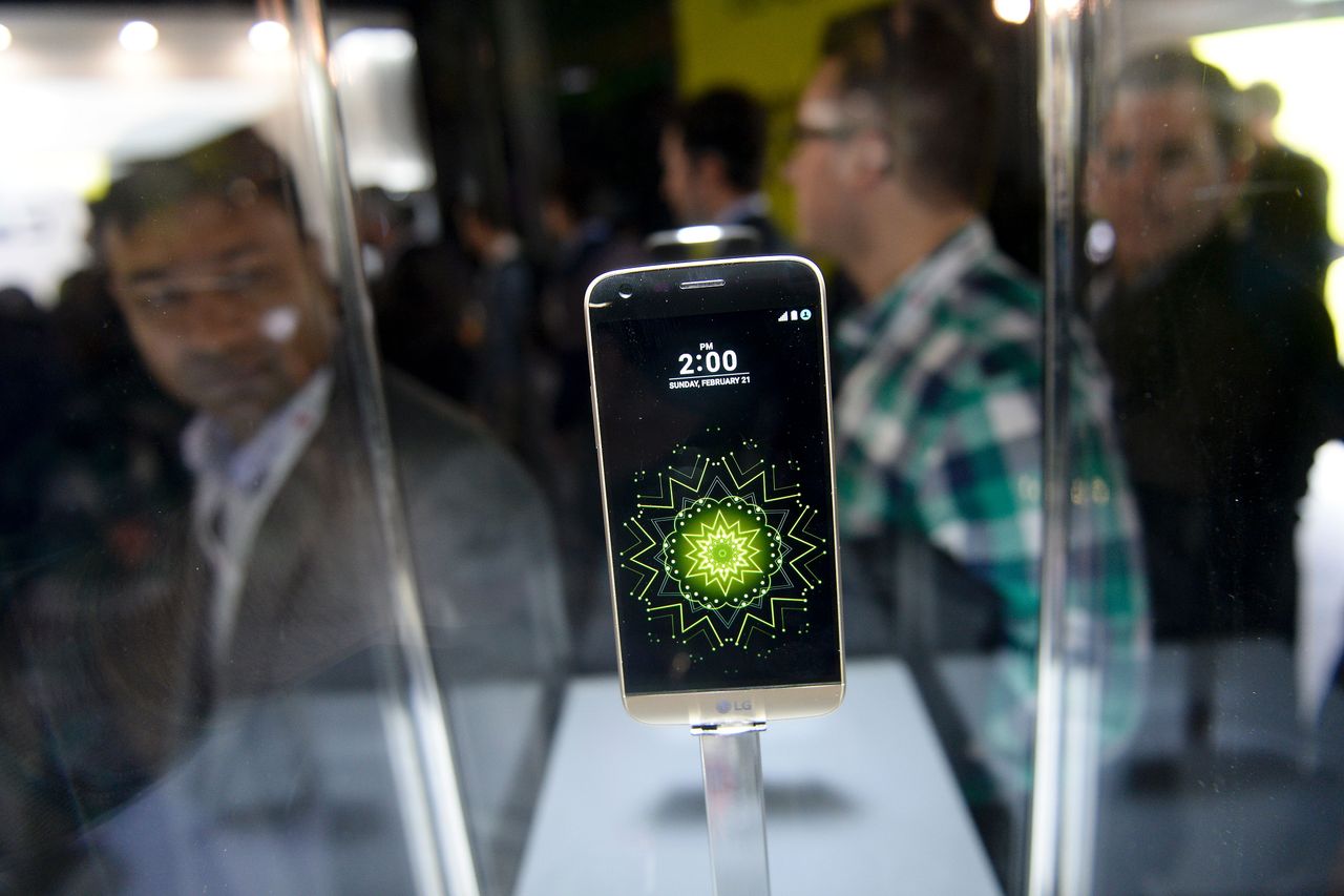 Visitors look at the new LG G5 model of South Korean multinational conglomerate corporation LG after its presentation on the eve of the official start of the Mobile World Congress in Barcelon