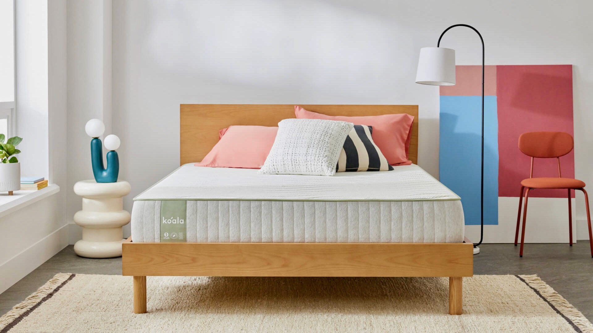 Koala Sleep Easy Mattress on a bed with pillows and a throw