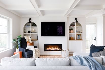 White living room with alcove shelving