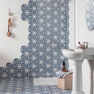 shower with blue patterned hexagon shaped tiles