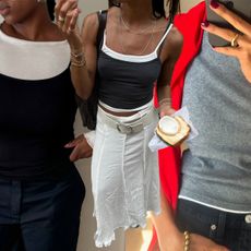 Collage of influencers outfit inspo. Marianne wears a grey and white tank with a red sweater. Nnenna wears a white long-sleeved shirt and a black tank on top of it. Amaka wears two tank tops and a white maxi skirt with a white belt. 