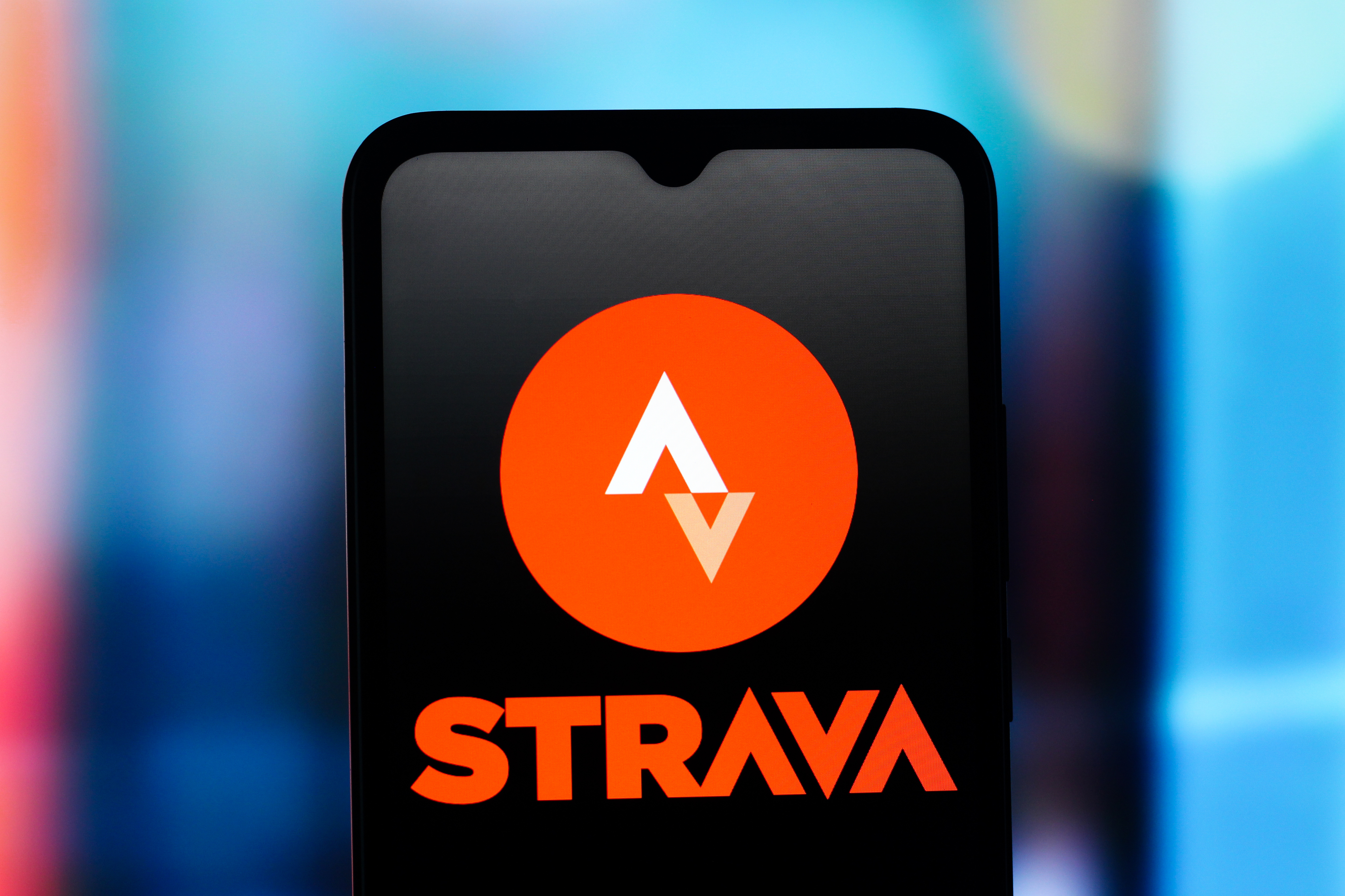 The Strava logo on a phone screen