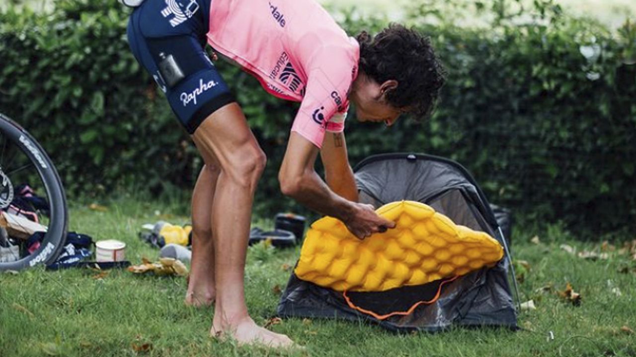 Lachlan Morton packing up his tent ahead of another long day on his Alt Tour