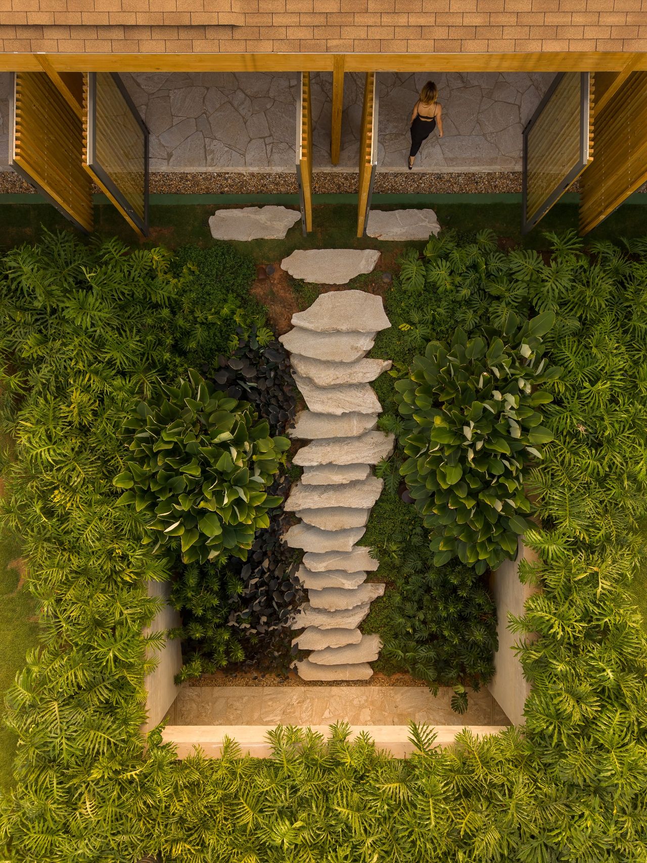 Stone steps lead down to the lower level