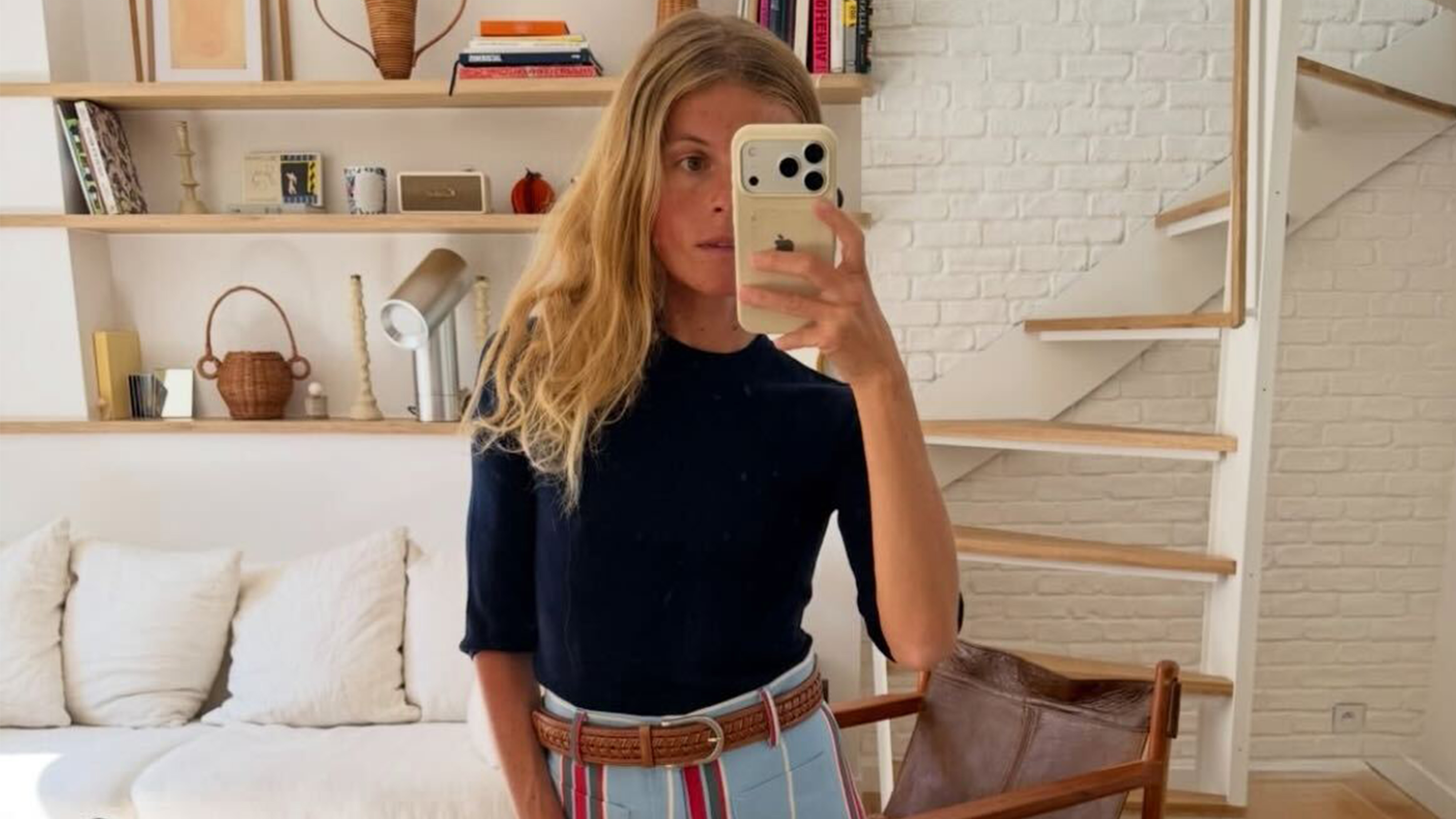 Alice wears a black shirt with blue stripe pants.