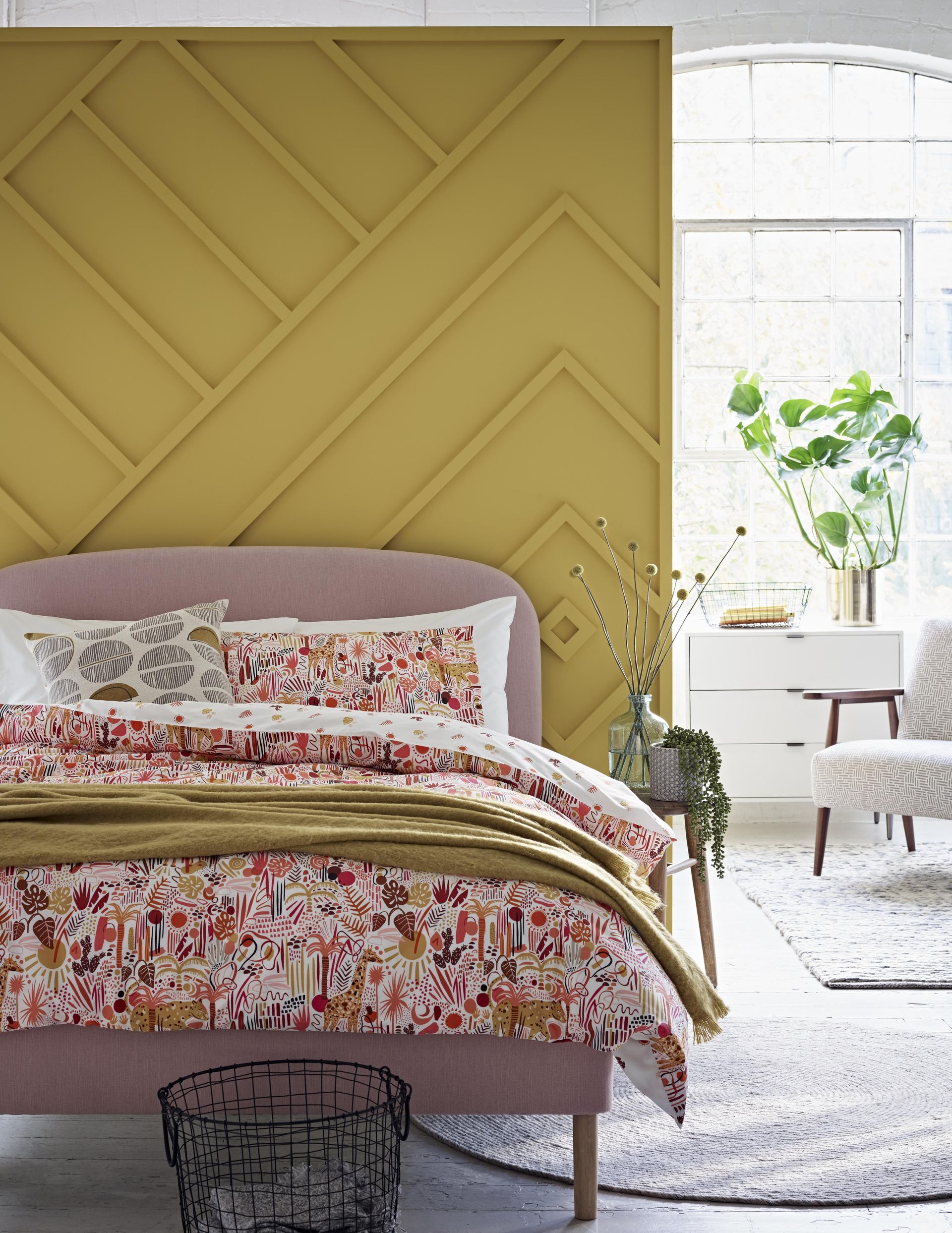a beaded feature wall with a bedroom in front, and light bright windows behind