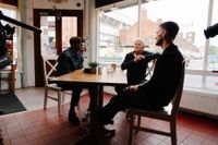 Ian Wright, Gordon Strachan and Andy Robertson sit in a cafe in the shadow of Anfield chatting around a table