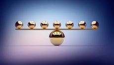 seven small gold balls balancing on one large gold ball