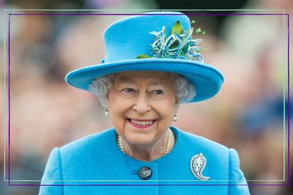 A close up of Queen Elizabeth II wearing a blue coat and hat