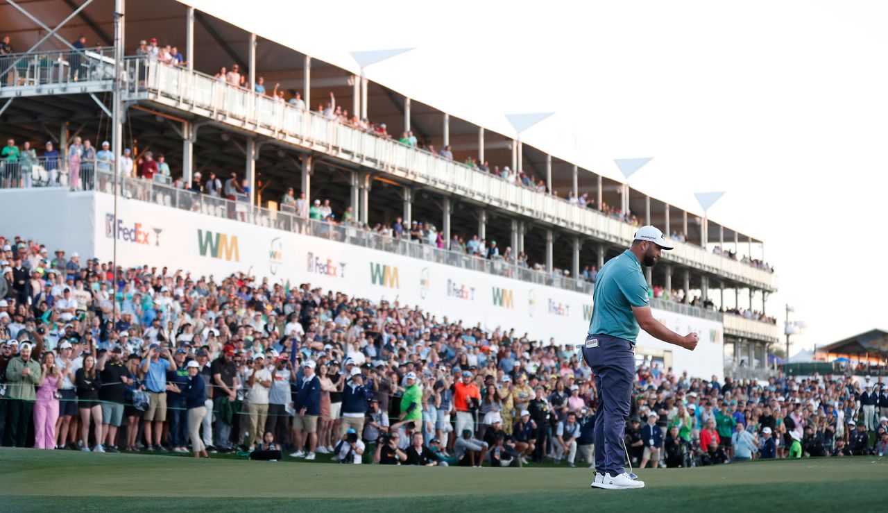 Rahm fist pumps when he holes his putt in front of Phoenix crowd