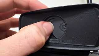 Elgato Facecam MK2's privacy shutter being closed by a reviewer