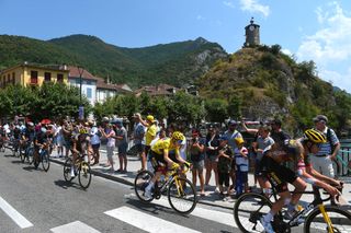 FOIX FRANCE JULY 19 Jonas Vingegaard Rasmussen of Denmark Yellow Leader Jersey Tiesj Benoot of Belgium and Team Jumbo Visma and a general view of the Peloton passing through Sailhan Village while fans cheer during the 109th Tour de France 2022 Stage 16 a 1785km stage from Carcassonne to Foix TDF2022 WorldTour on July 19 2022 in Foix France Photo by Dario BelingheriGetty Images