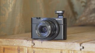 Sony Cybershot RX100 point-and-shoot camera on a wooden table