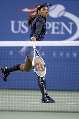 Serena Williams competes at the 2004 US Open wearing a denim skirt and nike knee high boots