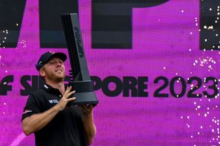 Talor Gooch holds the LIV Golf Singapore trophy aloft