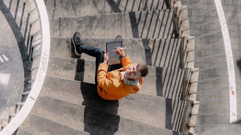 Maciej Łazowski interview; 2D to 3D art, a man draws on an iPad sat on a stone staircase viewed from above