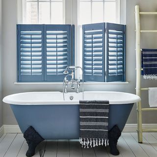 bathroom with free standing bath and shutters