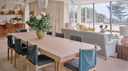 Open plan kitchen diner and living room with large windows
