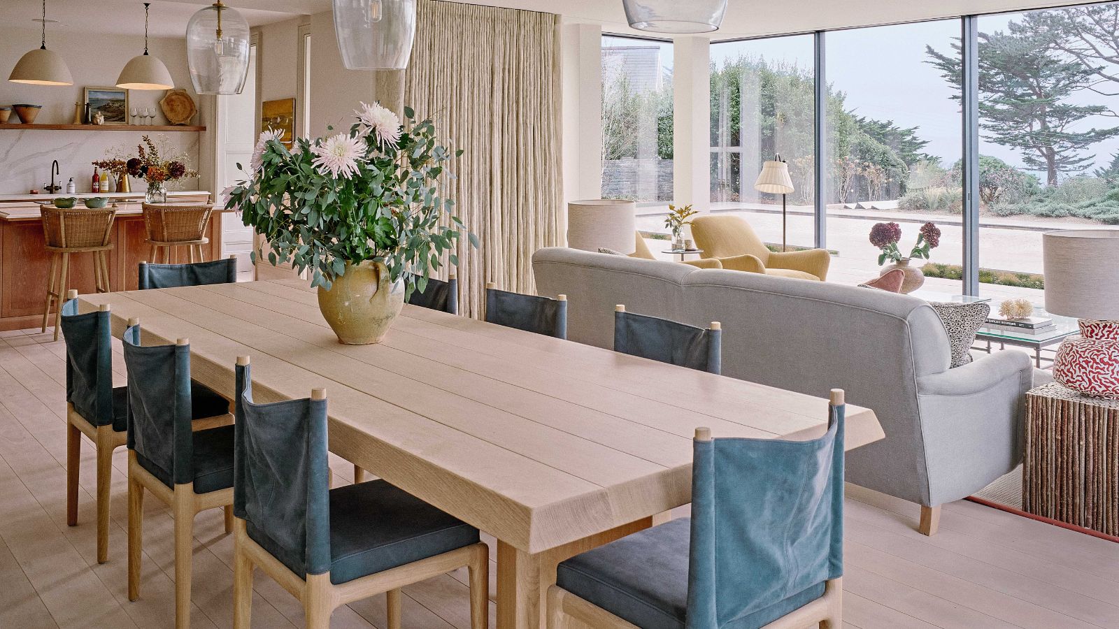 Open plan kitchen diner and living room with large windows