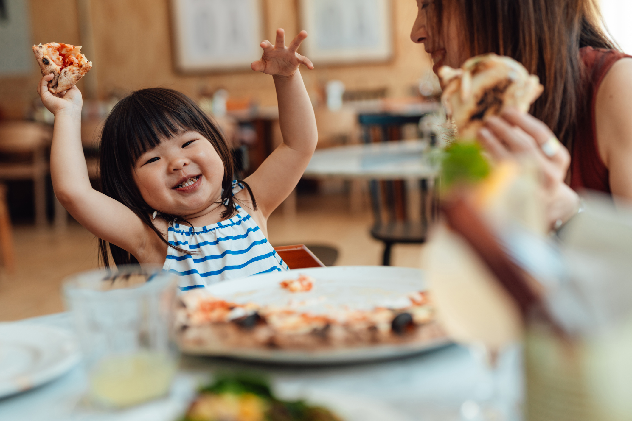 child eating pizza