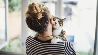 Woman hugging her cat