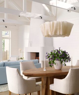 dining room with white walls and view to fireplace