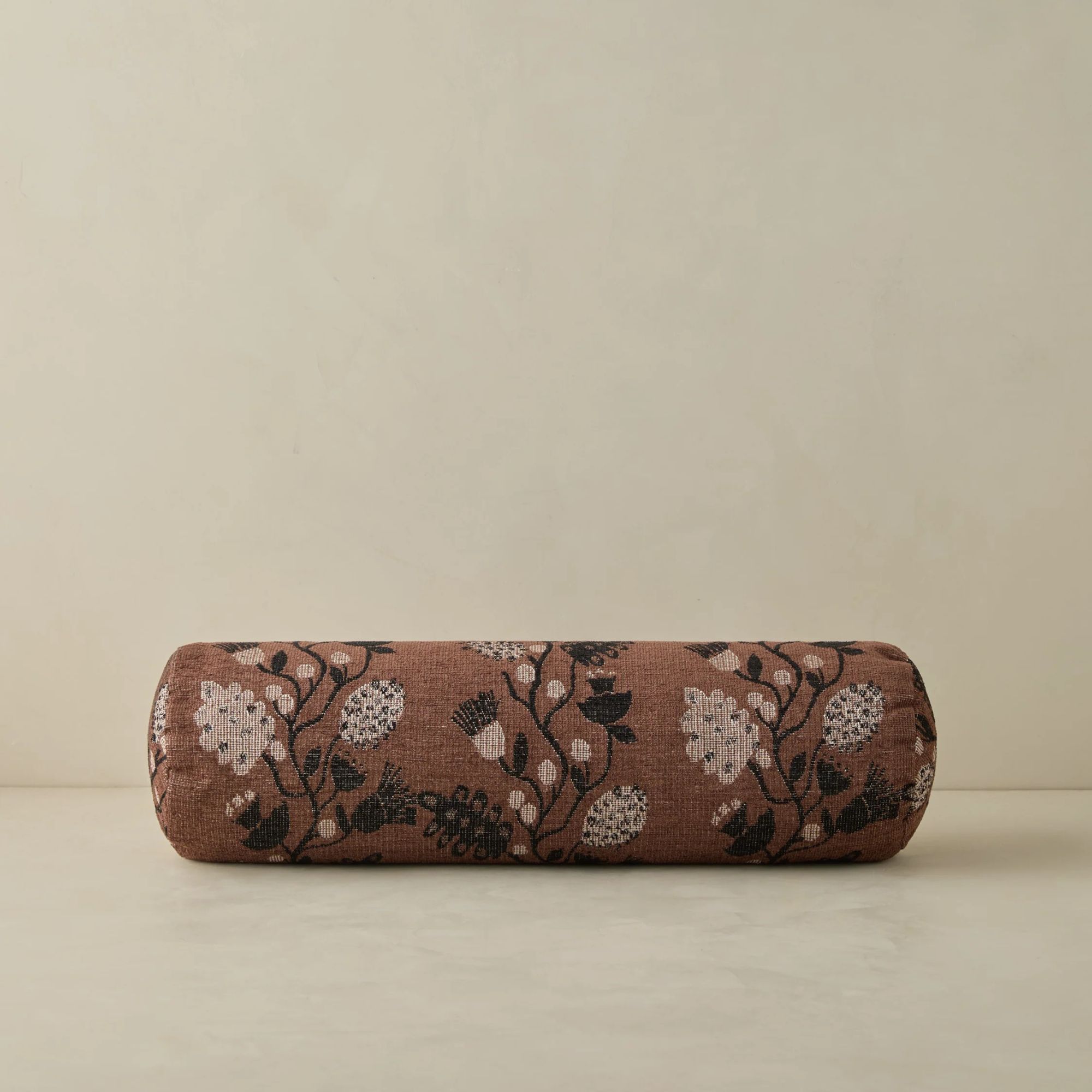 brown bolster pillow with floral print