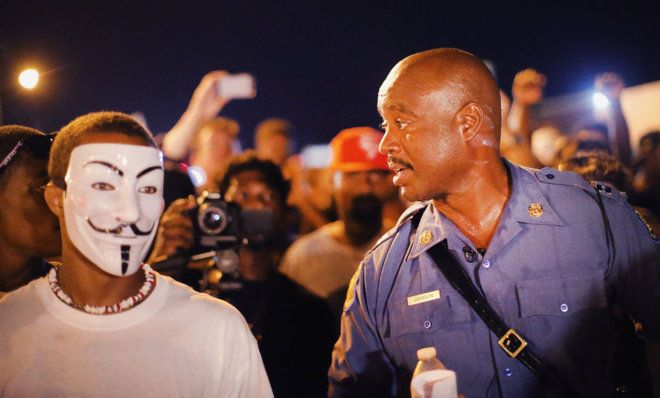 Capt. Ronald Johnson of the Missouri State Highway Patrol, who was appointed to take control of security operations in Ferguson, walks among demonstrators.