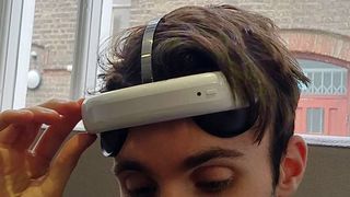   The Flow headset adheres to its forehead with two suckers 