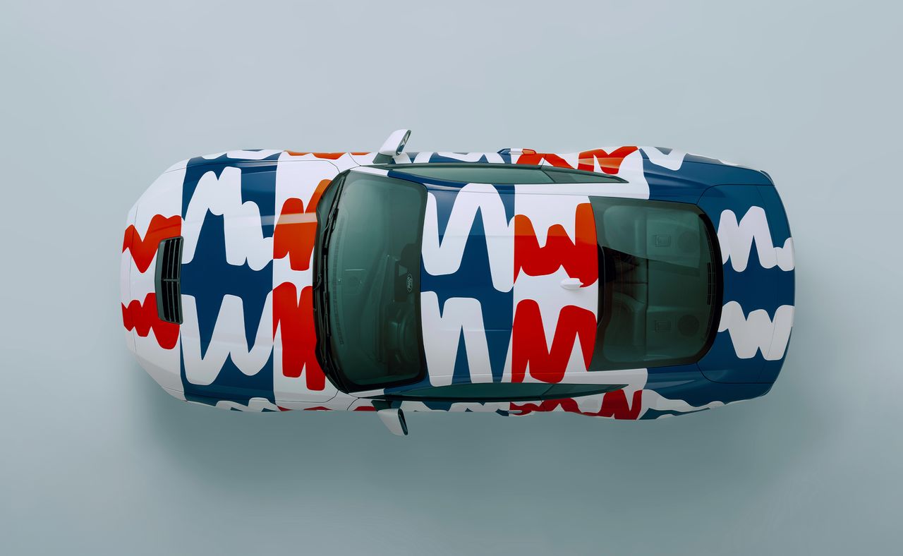 Photograph of the 60th year anniversary celebratory Mustang collaboration with Haus of Thrills. Top down view of white Mustang with colourful lines in white, red and blue with an occasional blue background.