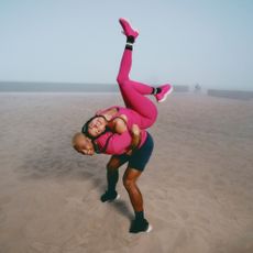 Two models on the beach wearing the new GlowUP lululemon collection playfully posing for lululemon discount codes