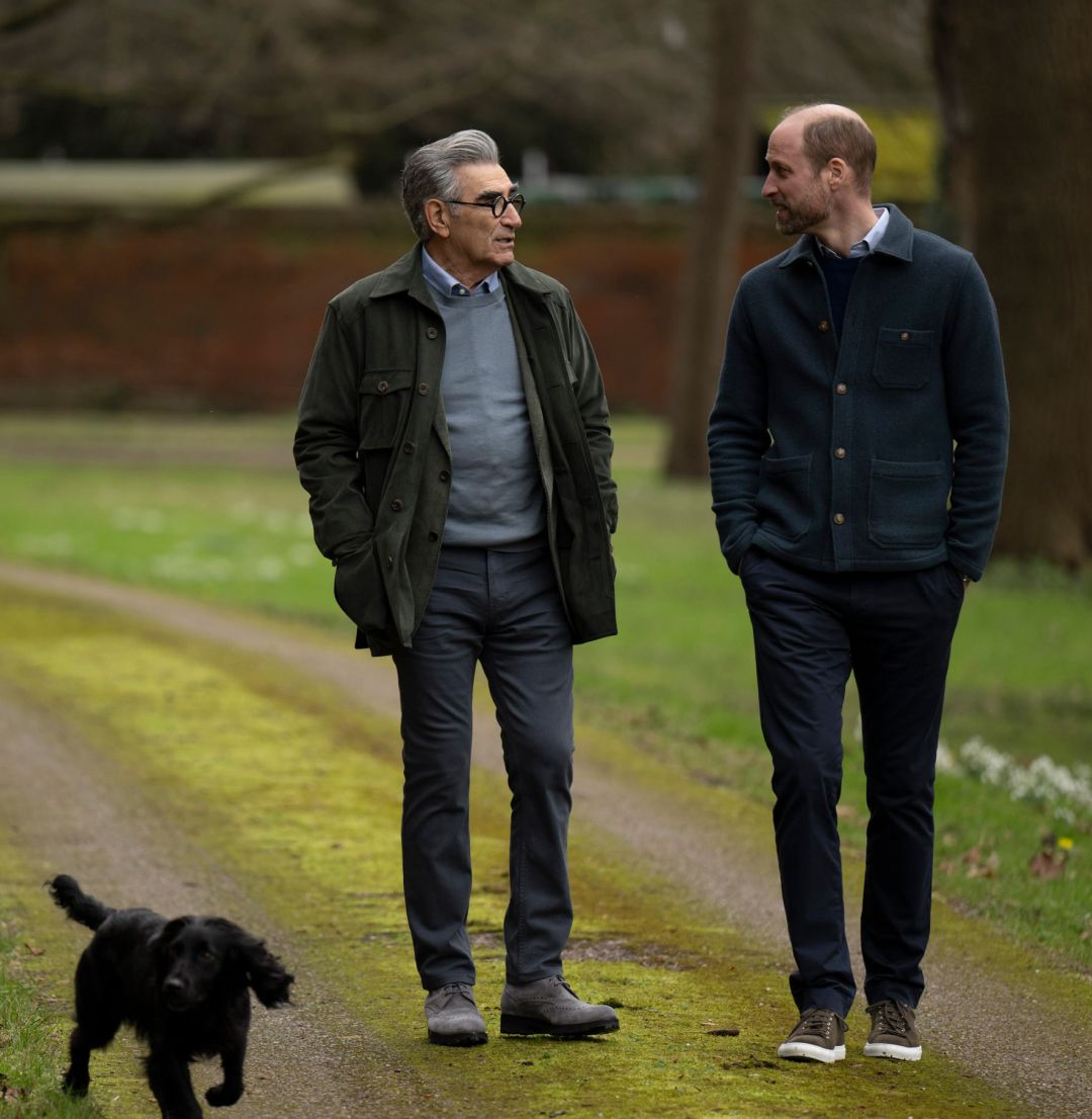 Prince William walking with Eugene Levy and Orla the dog through a park