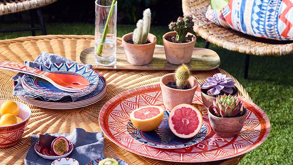 round table with plant in pots and green plant in circular glass vase