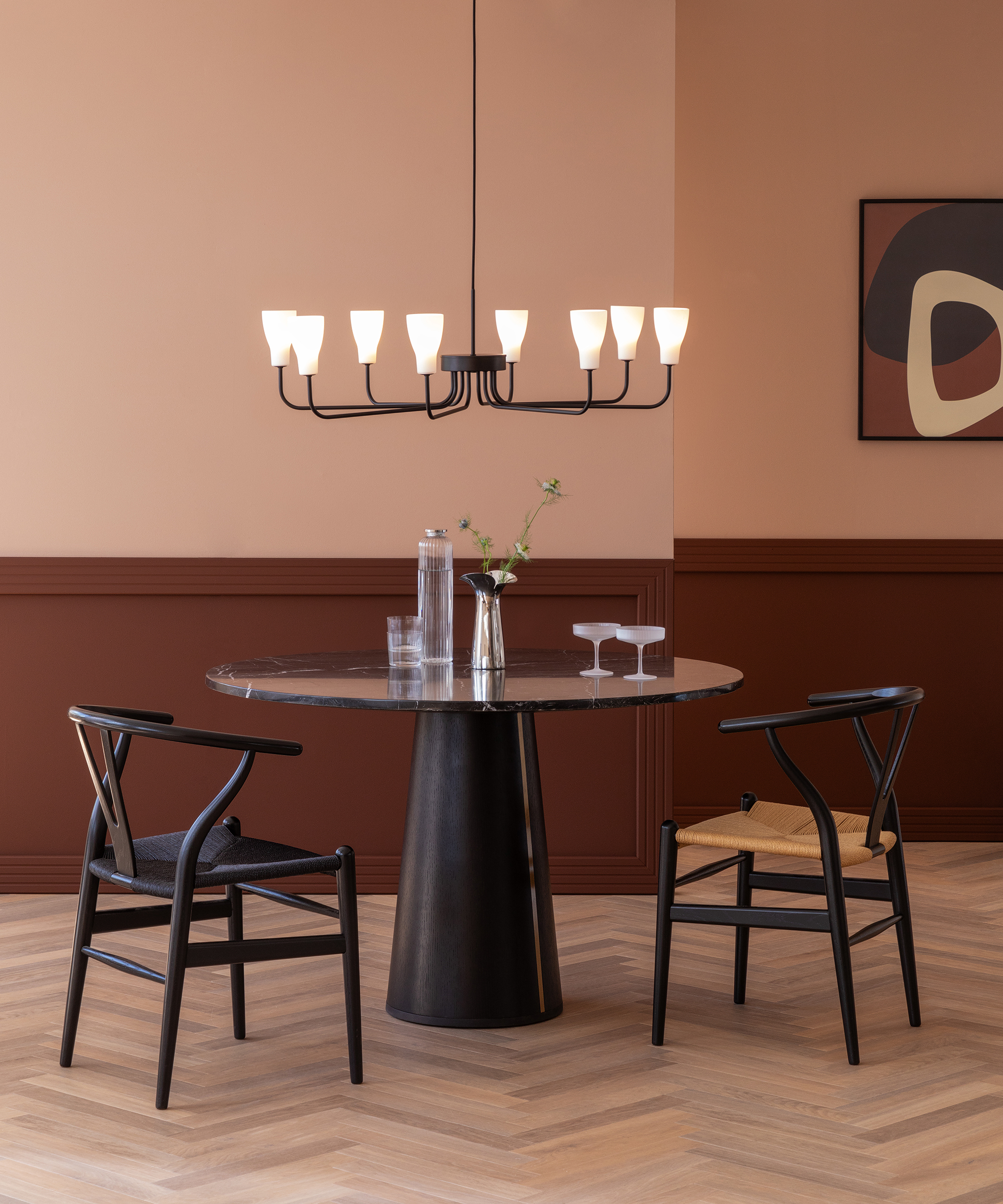 round black dining table in a pink and brown room
