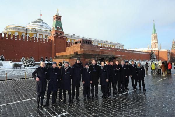 The riders pose in front of Lenin's Mausoleum