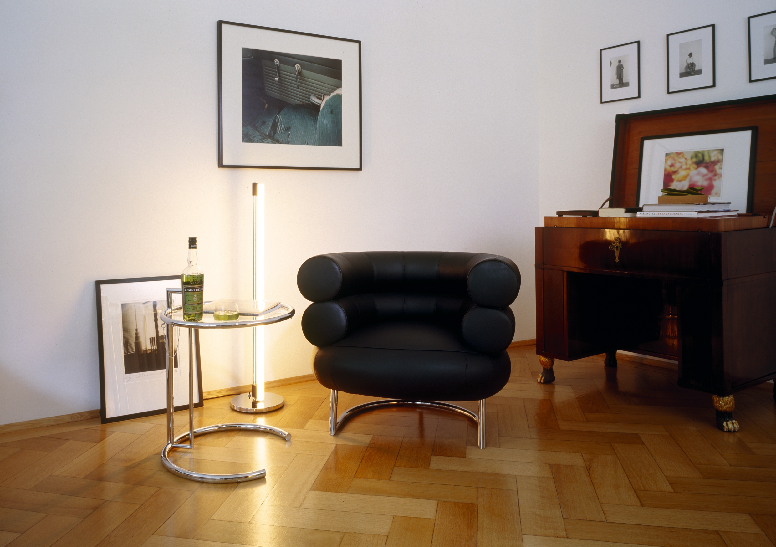 a bibendum chair in a room with wood floors, and other designs by eileen gray