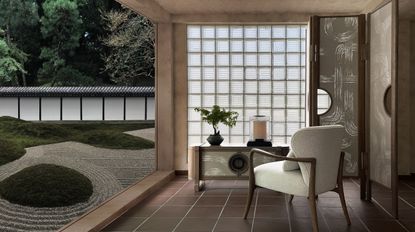 A living room space with furniture by Andre Fu, facing a traditional japanese zen garden with circular raked motifs