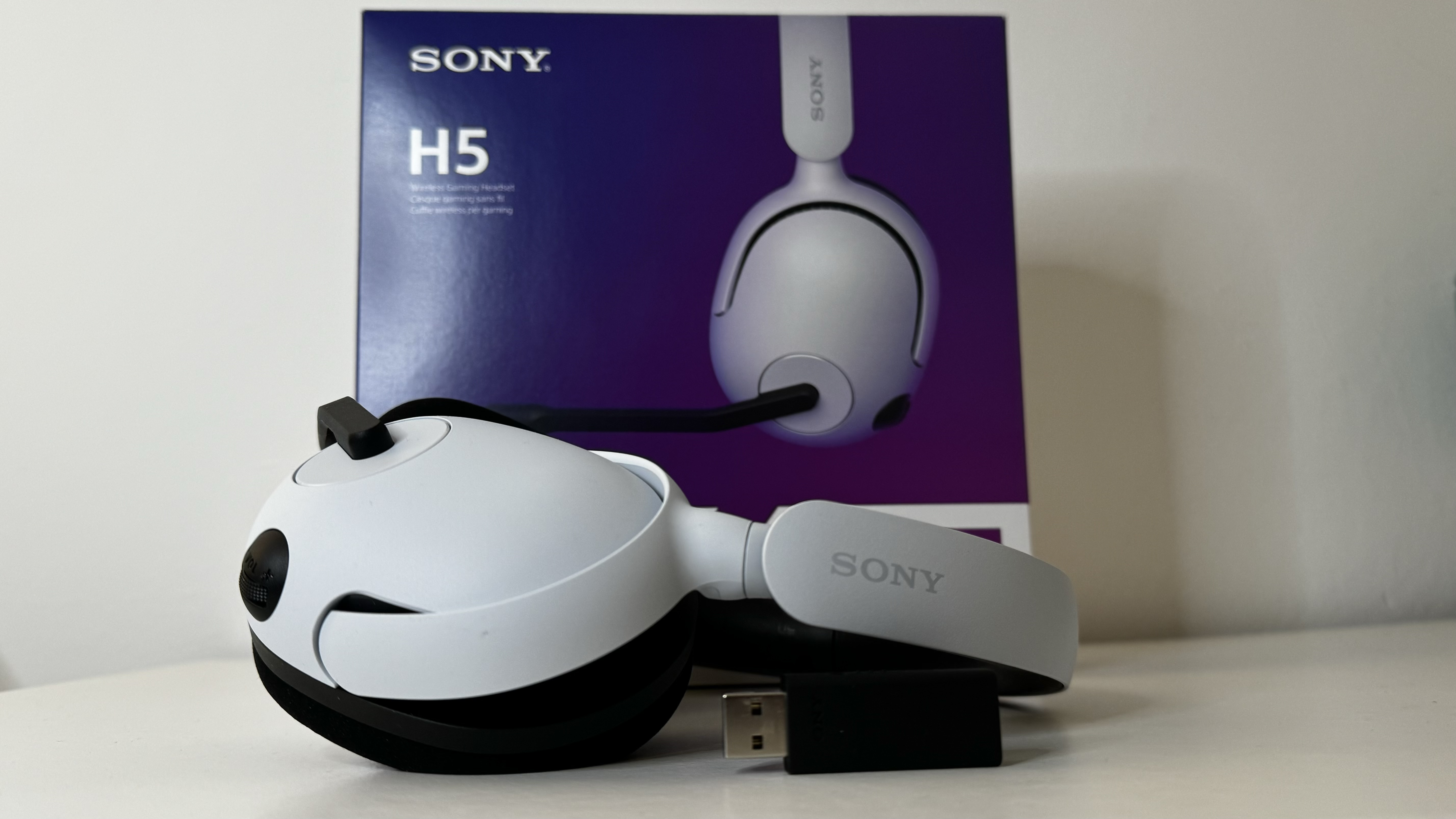 Sony InZone H5 gaming headset on a desk with packaging.