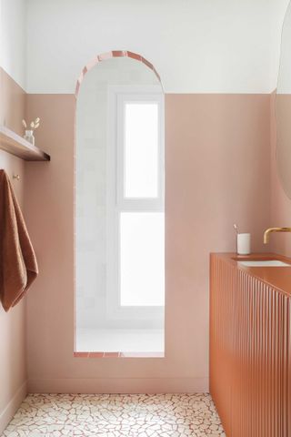 a bathroom with an orange opus incertum floor