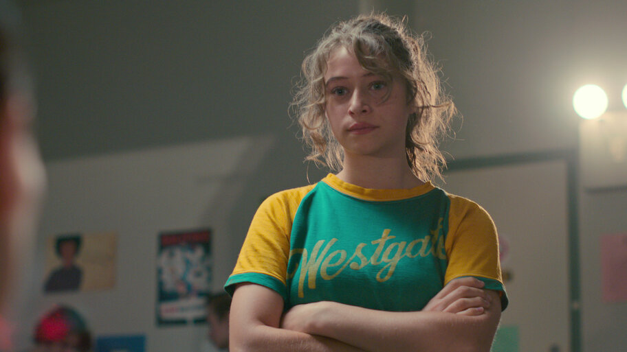 odessa a'zion crosses her arms while looking upset in a still from the netflix series grand army