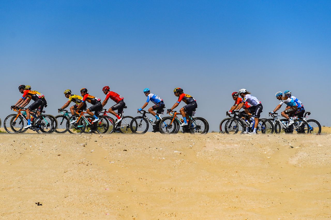 The riders pass through the sands dunes