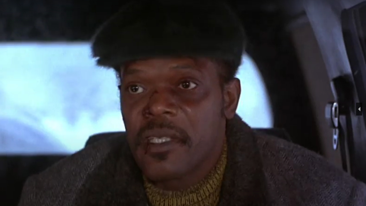 Samuel L Jackson talking as he sits in a car in The Long Kiss Goodnight.