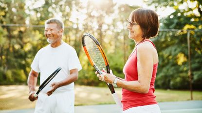 Two adults playing tennis together