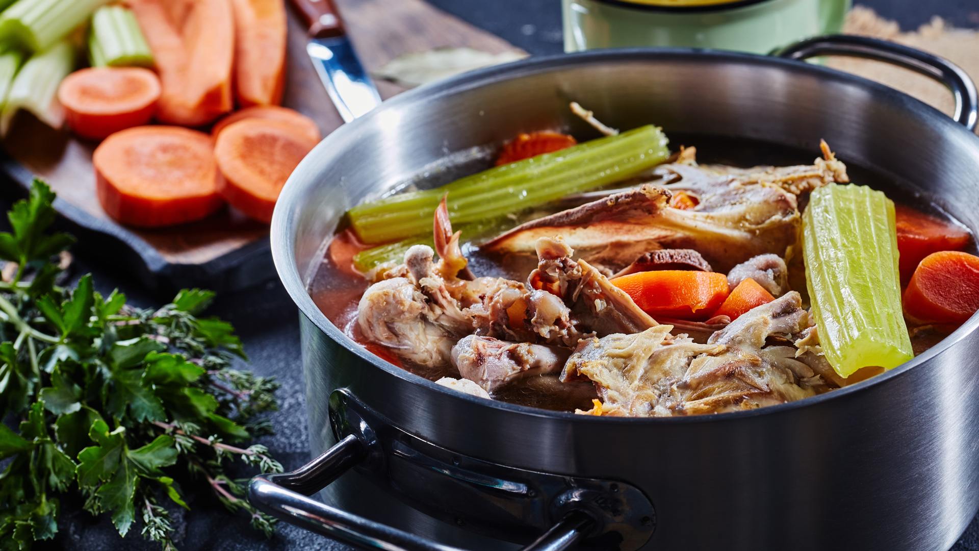 chicken stock and vegetables in a pan