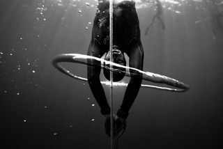 An upside-down freediver underwater