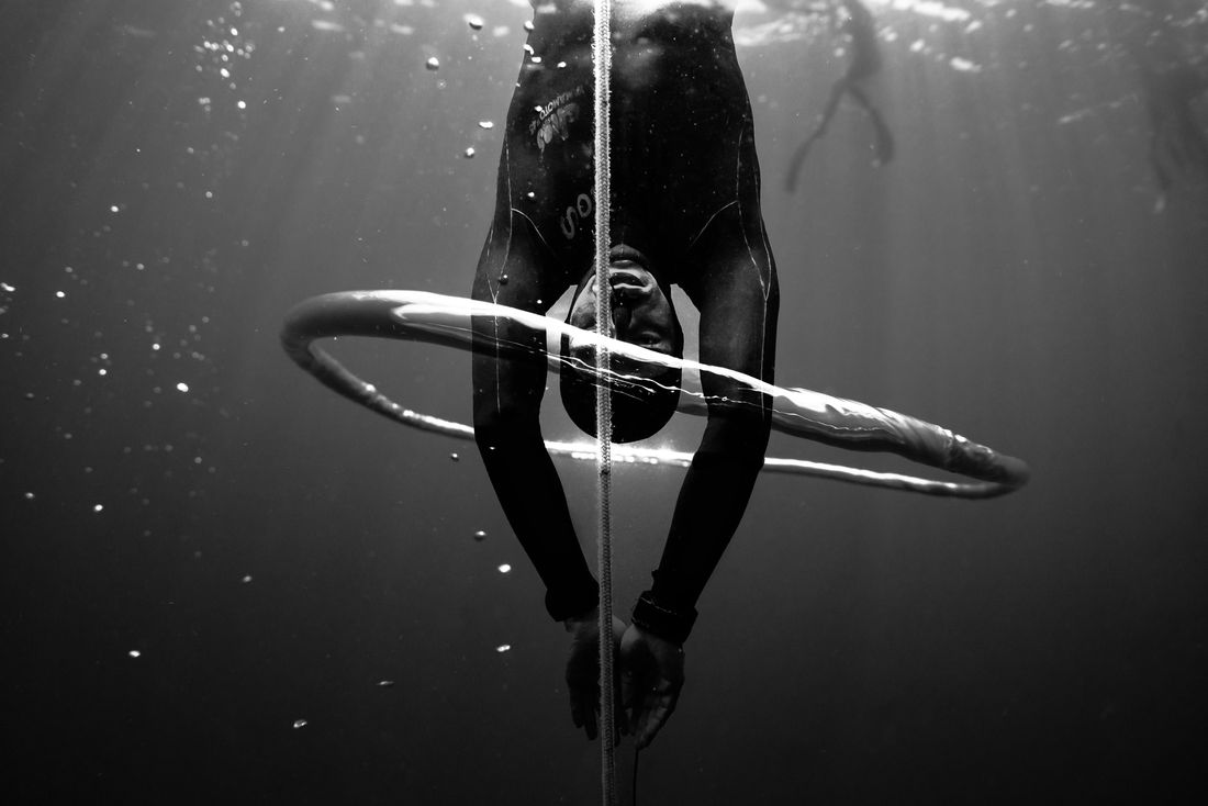 An upside-down freediver underwater