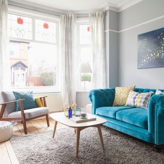 living room with blue sofa and coffee table
