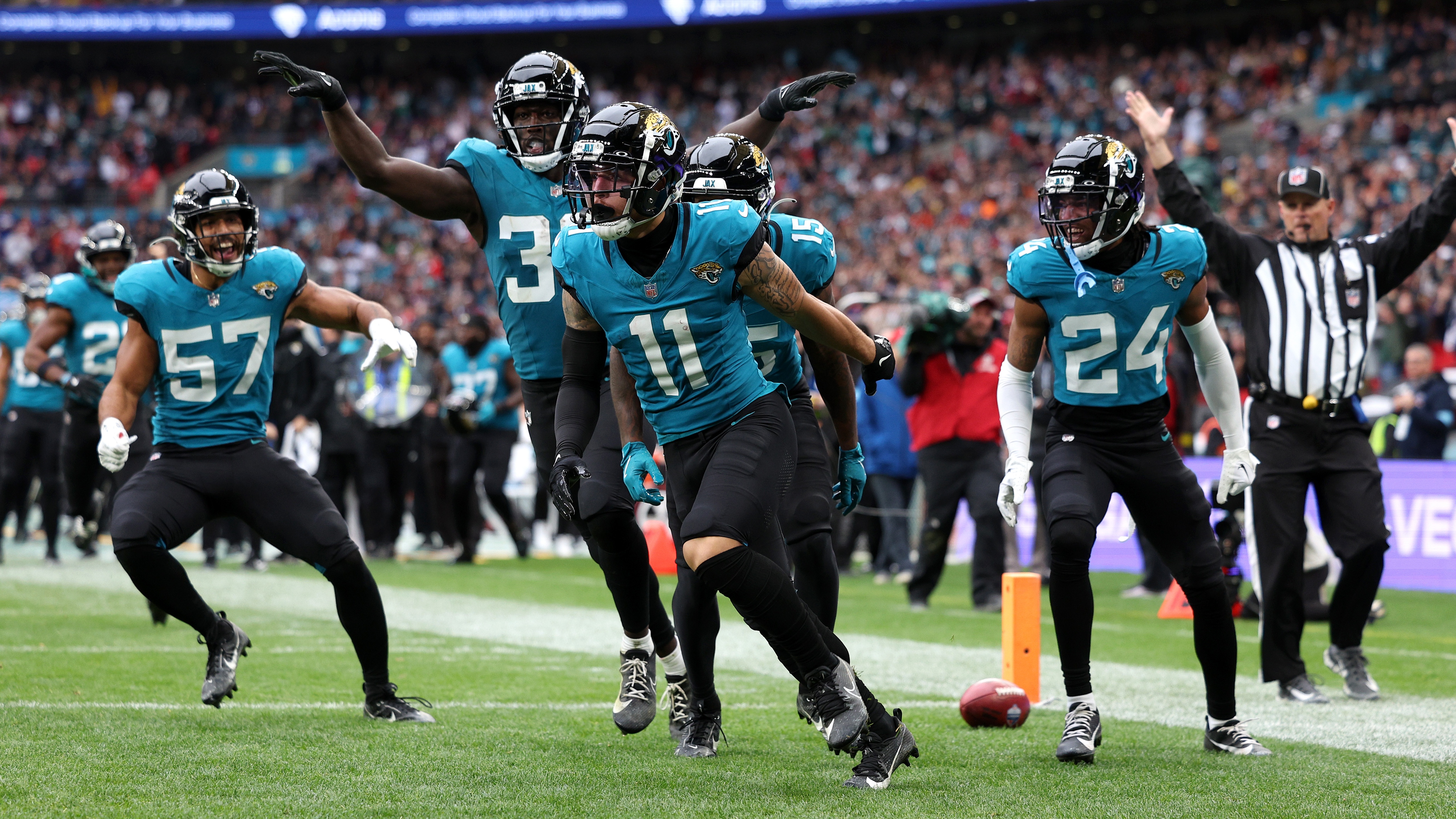 Parker Washington of Jacksonville Jaguars celebrates scoring a touch down with teammates during the NFL match between New England Patriots and Jacksonville Jaguars at Wembley Stadium on October 20, 2024 in London, England. 