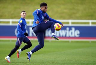 Reece James controls the ball ahead of Manchester City's Phil Foden in England training
